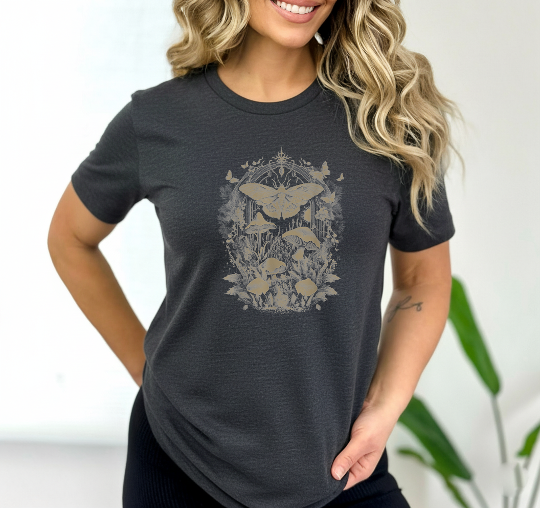 Woman wearing a dark gray t-shirt with a nature-themed graphic design.