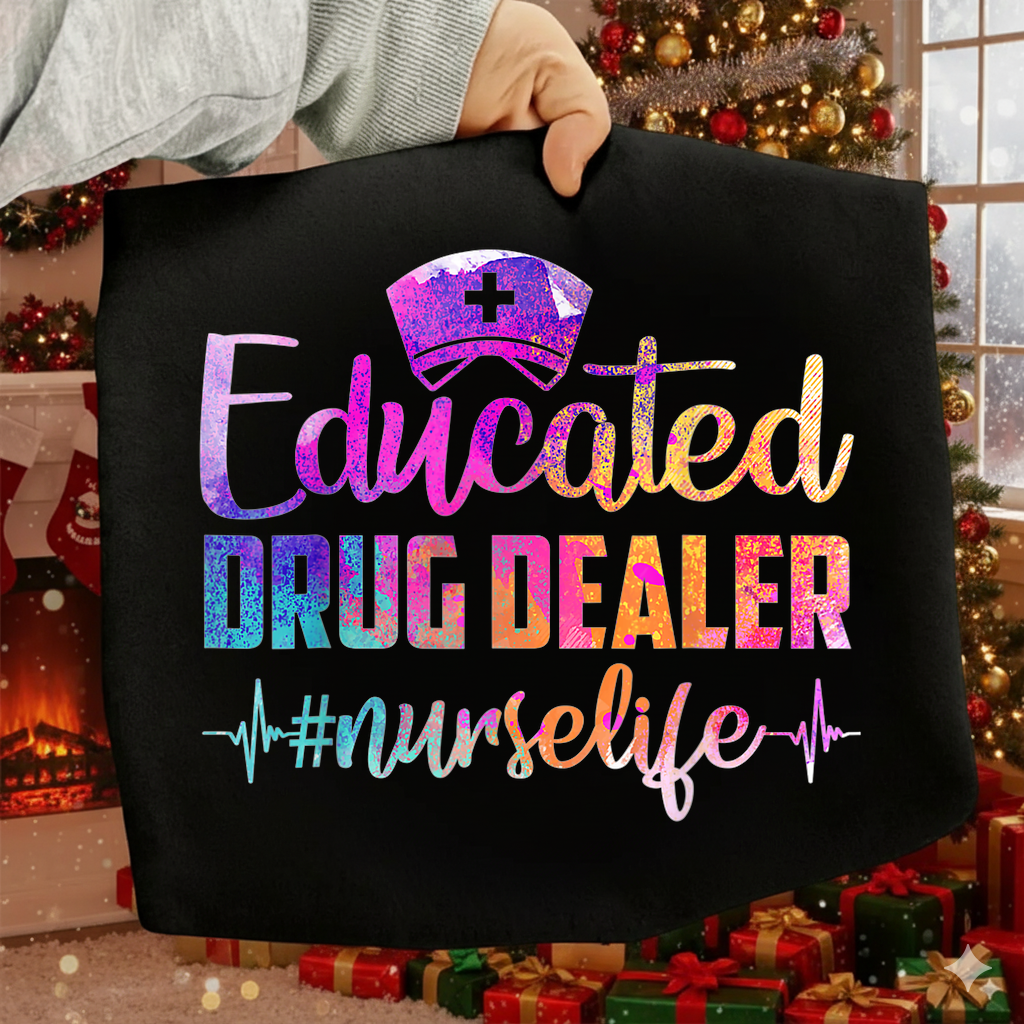 Black tote bag with colorful text 'Educated Drug Dealer #nurselife' held in front of a decorated Christmas tree.